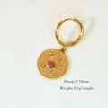 Detailed macro view of a 14mm gold hoop earring with a pink stone coin pendant - Pink Coin Star Moon