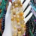 Natürliche gelbe Rutilquarz Kristallperlen mit goldenen Nadeleinschlüssen in der Hand - 6mm/ca. 62 Stück / 5A Tangerine Quarz