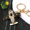 Golden airplane keychain featuring sparkling rhinestones and black enamel wing detail - Fighter Jet Black