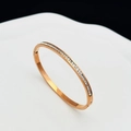 Macro shot of rose gold titanium bangle featuring full square-cut cubic zirconia inlay - Starry Sky Bangle Rose Gold
