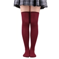 Close-up of burgundy three-stripe over-the-knee socks paired with a school uniform skirt - One Size / Pure Wine Red