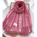 Detail of pink cashmere-feel scarf with tassel fringe and minimalist brand label - Pink