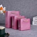 Three pink glossy gift bags in small, medium, and large sizes with golden rope handles - Pearlescent Burgundy