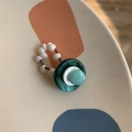 Macro shot of retro beaded ring with green resin stone on artistic ceramic plate - Style E Blue