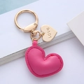 Close-up of pink leather heart keychain with gold spring clasp and Love engraved charm - Rose Red