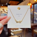 Golden star and shooting star necklace with pavé crystals on a branded gift card - X682 Gold Meteor Star