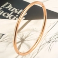 Detailed close-up of 4mm rose gold stainless steel bangle with polished finish and hinge - Simple Round Wire (Rose Gold) / Adjustable