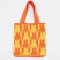 Close-up of thick knit texture with orange rabbit jacquard pattern on checkerboard tote - Orange & Yellow