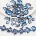 Detail of blue electroplated moon and star glass beads for DIY jewelry making - Plated Ink Blue