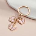 Pink acrylic butterfly keychain with sparkling rhinestones and golden metal ring - Pink