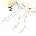 Golden eyewear chain with white shell beads and silicone loops on a minimalist background - 1014-3 (White)