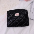 Quilted black cosmetic bag with pink slogan label and diamond pattern on white fabric - Clutch Bag / Black (Rock Barbie)