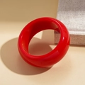 Close-up of a wide red resin bangle with glossy finish on a minimalist background - Solid Red High Gloss Wide Bangle
