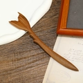 Macro detail of sandalwood hair stick featuring an intricately carved fish tail design - Fish Tail Shape Green Sandalwood (F2023751)