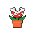 Cartoon enamel pin featuring a red piranha plant in an orange pot on metal badge - Orange Carnivorous Plant-Warning