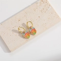 Golden monster leaf earrings with colorful enamel devil eye pattern on stone background - Wide Leaf (MA1-6)