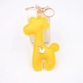 Detail of yellow PU leather giraffe keychain with golden hardware and crystal charm - Yellow