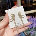 Orecchini eleganti con nappe in argento, design a fiocco e strass scintillanti - Nappa con fiocco dorata (E0146)