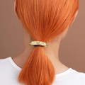 Golden hammer textured metal hair tie holding a ponytail with minimalist aesthetic - Gold Hammered Strip