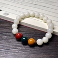 Detail of white Bodhi seed bracelet with cat claw charm and colorful beads on vintage book - White Jade Bodhi (Three-Color)