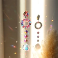 Rainbow crystal suncatcher with golden sun motifs casting light spots on the wall - Colorful Sun