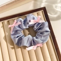 Blue floral lace scrunchie with pink silk ribbons on a beige velvet jewelry tray - Grey Blue Band Pink Bow