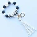 Detail of leopard print silicone beads bracelet with wood bead and white PU tassel - Black & White