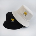 Detailed close-up of lemon embroidery on black and beige cotton bucket hats - Adult 55-58cm / Lemon Beige
