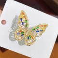 Detailed close-up of butterfly ring with colorful cubic zirconia and gold plating - Gold Color Multicolored Zirconia