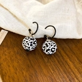Retro leopard print wooden bead earrings with C-shaped hooks on a rustic linen background - Black and White Leopard Print