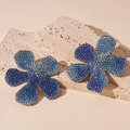 Macro detail of luxury flower earrings featuring blue and purple gradient rhinestones - Blue