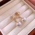 Macro shot of French style champagne flower pearl earrings on a wooden jewelry box - Champagne Pink Flower Large Pearl Style (ai-HE24197-7)