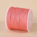 Single roll of 0.8mm coral pink nylon thread on a white spool for DIY hand weaving - Rose Pink