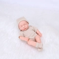 Sleeping 20cm reborn baby doll in beige and white striped romper on white plush mat - Beige & White Striped Style