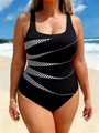 Detail of plus size swimsuit with black and white striped diagonal patterns on beach - Black