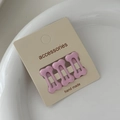 Macro shot of three pink bone-shaped mini hair clips on a handmade accessories card - Light Pink (Set of 3)