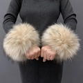 Detailed close-up of beige and brown faux fur wrist cuffs worn on a model - Khaki Jacquard