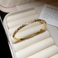 Detail of gold plated bangle showing pavé cubic zirconia links and hinge clasp - Alternating Micro-Pave Bar And Bead Style (6#)