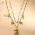 Detail of layered gold necklace with blue beads and celestial star-moon pendants - Star Moon Pendant Blue Beads Double Layer Stacking Necklace (XL110064)