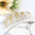 Detail of large hair claw clip in clear acrylic with gold foil flakes and marble accents - White