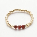 Detail of handmade beaded ring with gold metal beads and three faceted red natural stones - Gold Red