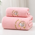 Detail of pink coral fleece towel featuring moon rabbit embroidery and soft plush texture - Moon Rabbit Pink