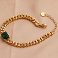 Elegant gold cuban link bracelet with rectangular green zircon on silk background - 18K Gold / Green Zircon