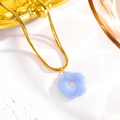 Macro detail of lavender acrylic flower pendant on a golden titanium steel snake chain - Royal Blue