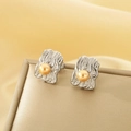 Detail of irregular textured silver square stud earrings with central gold pearls - Steel Color (KE115084-K)