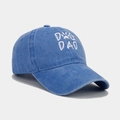 Close-up of DOG DAD embroidery on washed blue cotton baseball cap with a dog paw icon - Adjustable / Blue