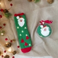 Fuzzy Christmas socks in red and green with Santa patterns in festive gift ornament - Green Santa