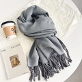 Elegant grey faux rabbit fur scarf with fringe on a minimalist coffee table setup - Medium Gray & Light Gray