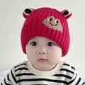 Cute red knitted baby hat featuring cartoon frog eyes and embroidered face detail - Smiling Frog - Red
