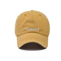 Close-up of ginger yellow washed cotton baseball cap with white REMEMBER embroidery - Washed Yellow
